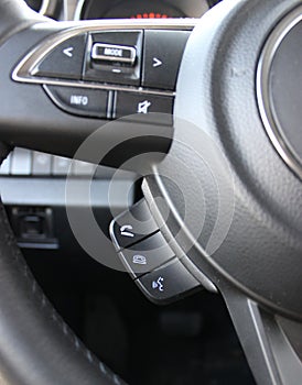 Hands Free Phone Buttons Under Steering Wheel In Car Closeup View