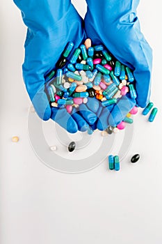 Hands full of medication. Tablets and pils