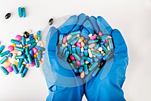 Hands full of medication. Tablets and pils