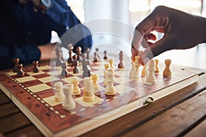 Hands, fun and people with a chess game, strategy and playing together at a competition. Table, professional and friends