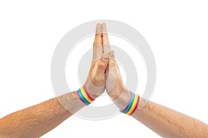 Hands with gay pride wristbands make high five