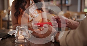 Hands, gift and date at dinner restaurant for valentines day or celebrate together for bonding, connection or love