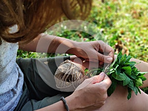 the hands of the girl with a bunch of mint