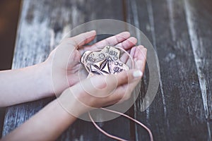 Hands of girl holding crucifix for holy confirmation or communion.