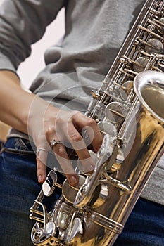 Hands girl playing the saxophone