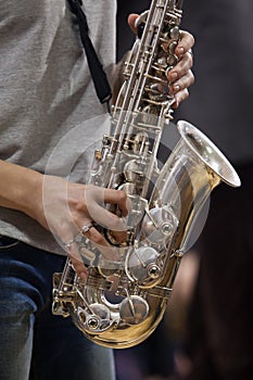 Hands girl playing the saxophone