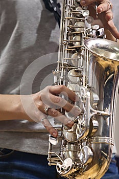 Hands girl playing the saxophone