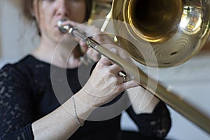 Hands of a girl playing the trombone