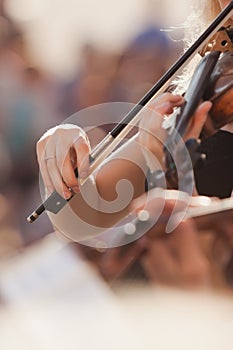 Hands of the girl playing the violin