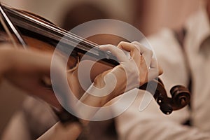 Hands of the girl playing the violin