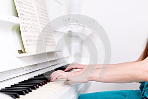 Hands girl who plays the piano. Selective focus.