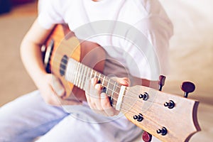 Hands girls play the guitar. A child learns to play the guitar. Selective focus. Close-up. The concept of music and art