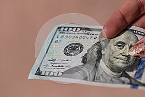 Hands giving money like a bribe or tips. Holding US dollars banknotes on a blurred background, US currency