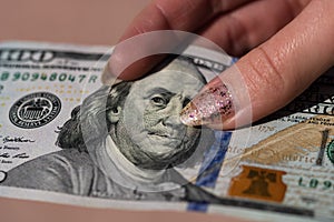 Hands giving money like a bribe or tips. Holding US dollars banknotes on a blurred background, US currency