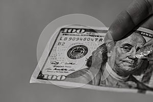 Hands giving money like a bribe or tips. Holding US dollars banknotes on a blurred background, US currency