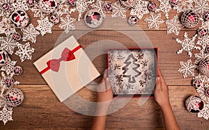 Hands giving or receiving christmas present - in seasonal decorations frame