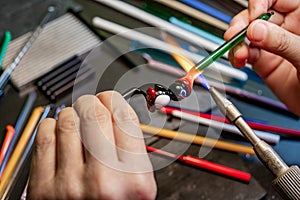 Hands of the glassmaker, shaping figurines from murano glass.