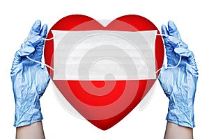 Hands in gloves hold medical face mask and red heart white background isolated close up, love life safety symbol, pritection
