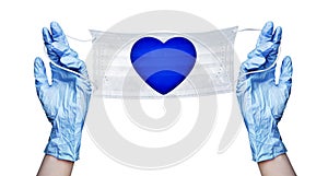 Hands in gloves, medical face mask, blue heart pattern, coronavirus protection on Valentines Day concept, love and safety symbol