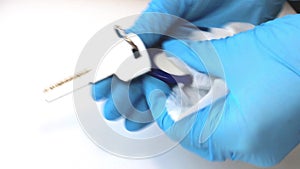 Hands in gloves process keys from the apartment or from the house with an antibacterial napkin.