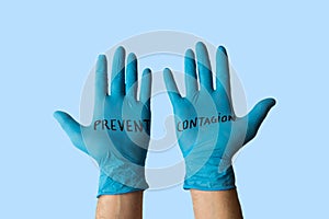 Hands with gloves with written on it prevent the infection. Health prevention and safety concept