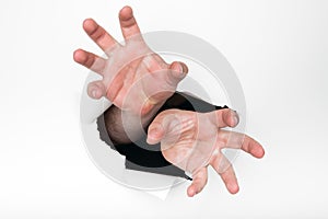 Hands grasping through hole photo