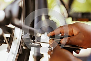 Hands grasping multitool for bike repair photo