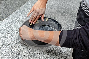 Hands greasing a cake pan