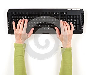 Hands in green jacket and black keyboard