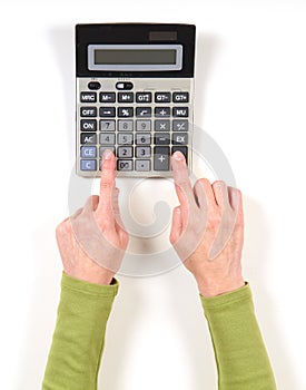 Hands in green jacket and grey calculator