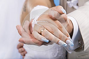 Hands of groom and bride.