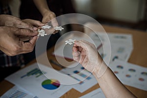 Hands group of business people assembling jigsaw puzzle white. B