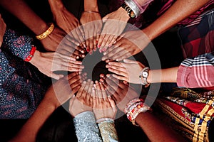 Hands of a group of multinational people which stay together in circle.