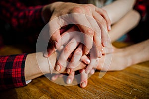 Hands of a group of young friends hanging out at a coffee shop. Young men and women meeting in a cafe having fun. Lifestyle, frien