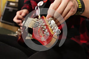 hands guitarist, musician tunes strings