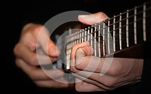 Hands of the guitarist playing