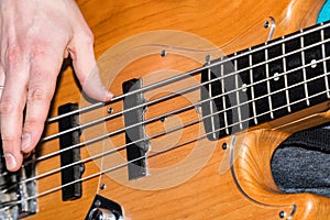 Hands of the guitarist`s bass