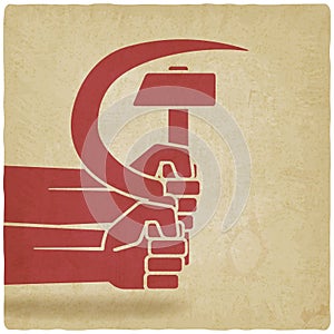 Hands with hammer and sickle old background