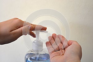 Hands and hand sanitiser in gel pump