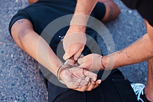 Hands, handcuffs and man on floor with police agent, justice and human rights in Iran to stop protest. Crime, law and