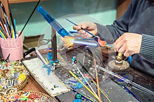 Hands of handicrafts man makes glass subjects