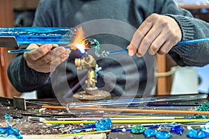 Hands of handicrafts man makes glass subjects