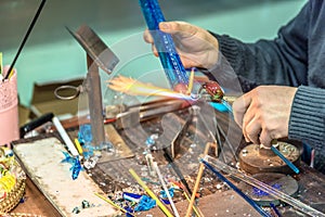 Hands of handicrafts man makes glass subjects