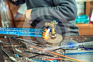 Hands of handicrafts man makes glass subjects