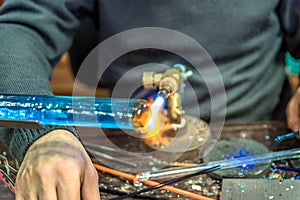 Hands of handicrafts man makes glass subjects