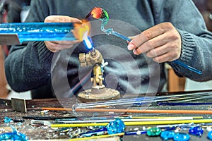 Hands of handicrafts man makes glass subjects