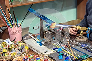 Hands of handicrafts man makes glass subjects