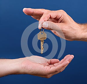 Hands handing over house key