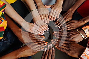 Hands of happy group of multinational African, latin american and european people which stay together in circle