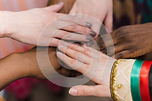 Hands of a happy group of people of different nationalities who stay together in a circle of happy ones. A team of people of Afric